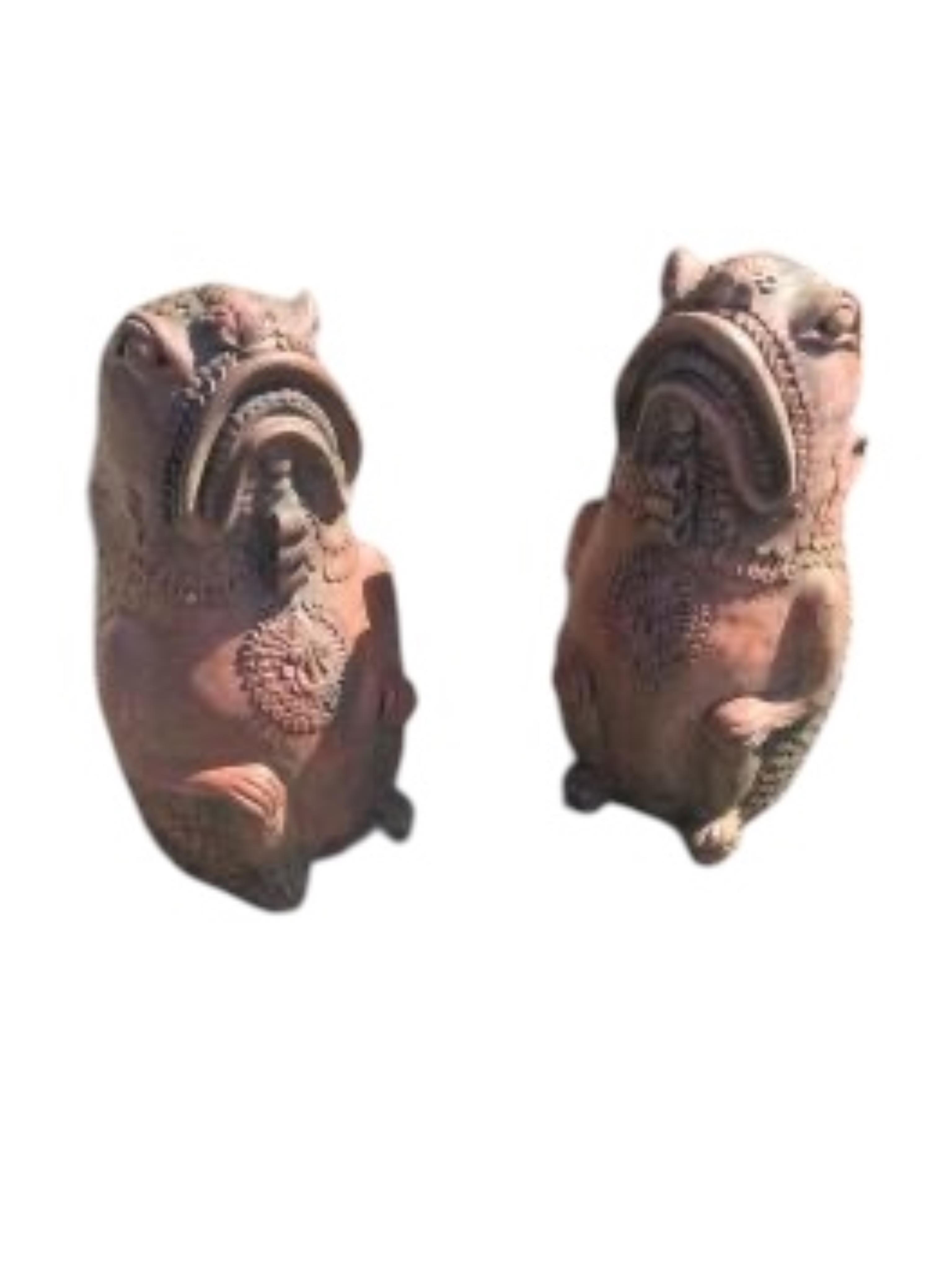 A pair of cast terracotta Oriental fish garden ornaments, height 61cm